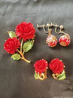 Group shot of brooch, clip-on rose earrings and screw-back bead earrings