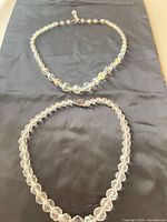 Both necklaces laid flat to show length, bead style, and clasps