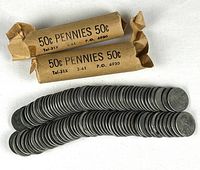 Two paper coin rolls and roughly 100 steel pennies laid out