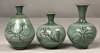 Front view of all three celadon vases showing shapes and motifs
