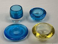 Group shot of four thick-walled art glass holders
