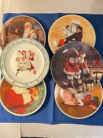 Group shot of all six Norman Rockwell Hallmark Christmas plates