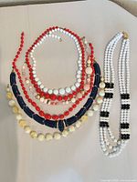 All five necklaces laid out showing overall design and colors