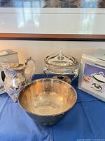 Overall lot showing punch bowl, pitcher in packaging, chafing dish with box
