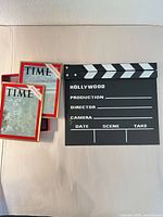 Front view showing both framed Time covers and Hollywood clapperboard