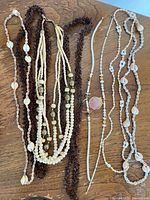 All six necklaces laid out showing variety of styles and colors