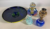Group shot of all five glass items: Murano bowl, faceted perfume bottle, Caithness vase, Czech gilt vase, Bohemian dinner bell