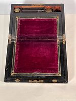 Top view open showing velvet writing surface, compartments, inkwell