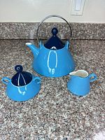 Teapot, sugar bowl with lid, and creamer grouped