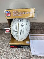 Wilson NFL Autograph Football in original box, signatures visible