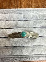 front view showing turquoise cabochon and feather design