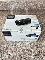 Front and top view of sealed Sony HDR-CX220 Handycam retail box