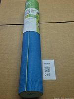 Rolled yoga mat with Gaiam sleeve showing product details