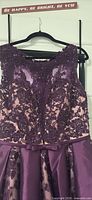 Front close-up showing lace, beadwork, sheer neckline, waist bow