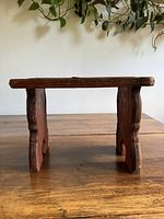 side view of rustic red wooden footstool