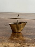 Front view of brass mini bucket showing tapered shape and handle