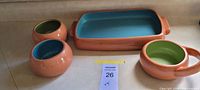 Full set showing casserole, two bowls, handled bowl