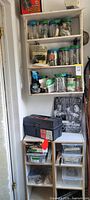 Full view of wall-mounted shelf with jars, decorative sign, toolbox on melamine shelves