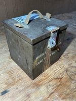 Front view showing stencil text, hasp and rust streaks