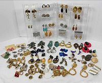 Wide shot of entire assortment of clip-on earrings displayed on acrylic stands and tabletop