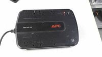 Top view showing APC Back-UPS 550 with outlets and power indicator