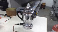 Front and side view of Farberware electric percolator showing body, handle and power cord