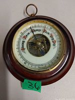 Front view of round mahogany-tone barometer