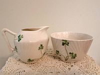 Creamer and sugar bowl side by side showing pattern