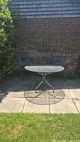 front view of patio set showing table and two chairs on patio