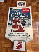 Poster laid flat with VHS, CD and brochure nearby