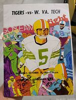 Front cover showing colorful football illustration and game details