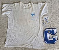 Entire lot laid out: T-shirt, patch, buttons