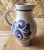 Front view showing swirl decoration, handle and spout