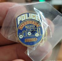 Front view of sealed NYPD Emergency Squad enamel pin