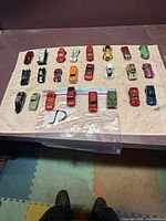 Top view of 24 die-cast cars laid out on cloth