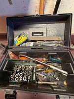 Open toolbox showing sockets, ratchets, wrenches and other hand tools