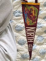 Front of maroon felt pennant with printed graphic and text