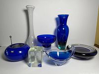 Group view of all seven blue and clear glass pieces