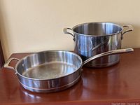Both sauté pan and stock pot side by side