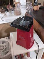 Front angled view showing full popper with clear chute attached and power cord