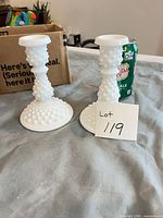 pair of white milk glass hobnail candlesticks side by side with soda can for scale