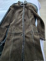 Full view of Bisang brown shearling coat laid flat