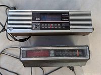 Front view showing both GE clock radios, tuning dials and grilles