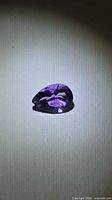 Pear-shaped faceted amethyst showing table and crown facets