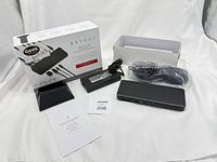 All components: dock, power brick, power cable, stand, manual, box