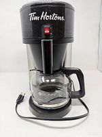 Front view showing Tim Hortons branding, carafe, power cord
