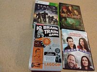 Lot overview showing all four items arranged: Halo Reach game, Pirates of the Caribbean DVD, IQ Brain Train tin, America's Sweethearts DVD