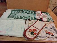 All six kitchen textiles laid flat on table