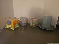 All four candles and holders grouped together