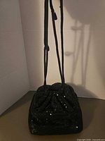 Front view showing sequin-covered exterior and drawstring cords